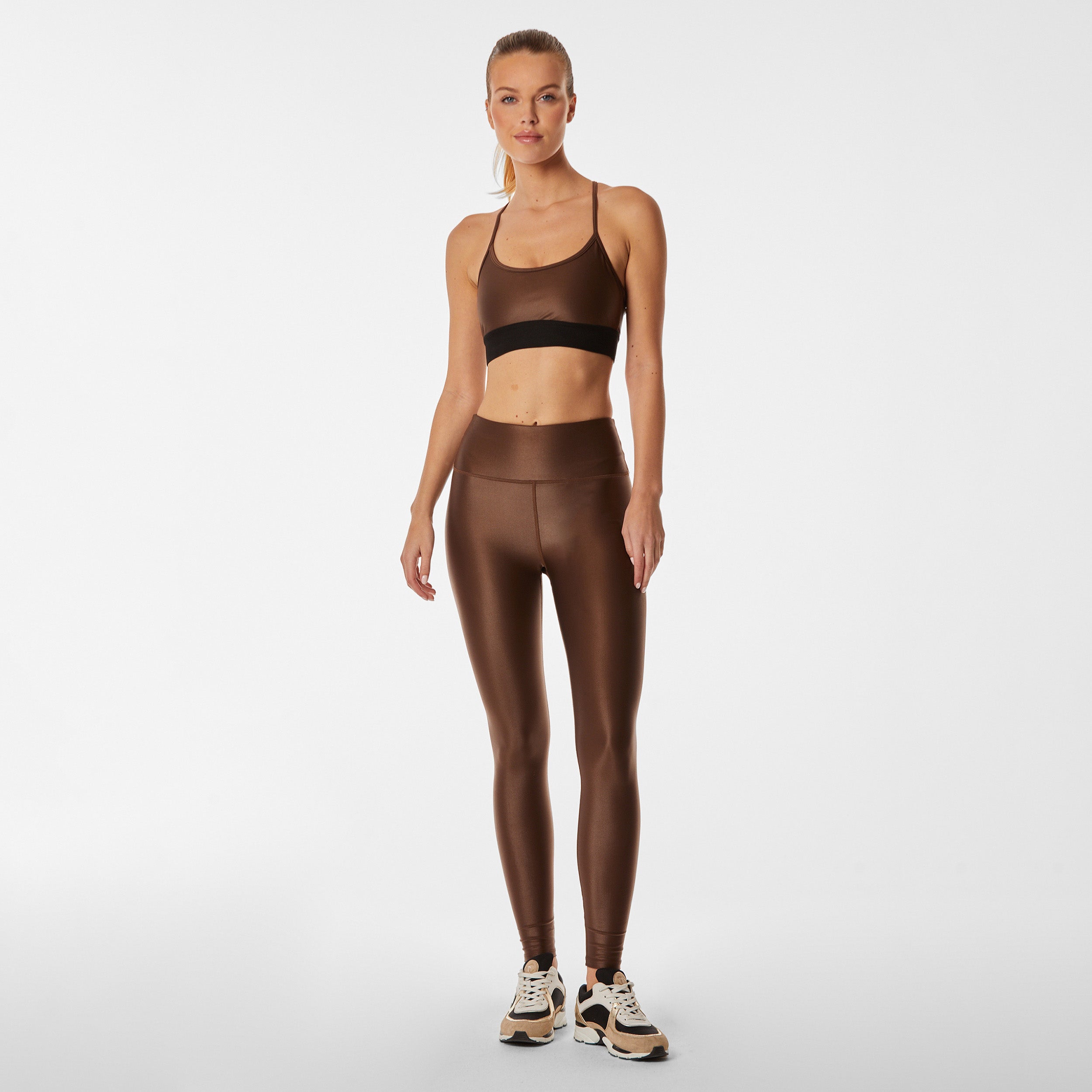 Full body view of lightweight, lustrous shine, quick drying brown liquid leggings