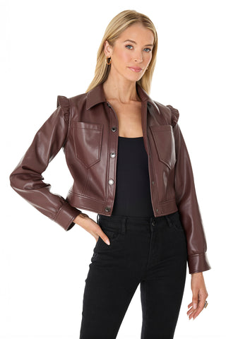 A woman with long blonde hair showcases the Chantal Ruffle Sleeve Leather Jacket in Espresso over a black top and pants, creating a chic fall look against a white background.