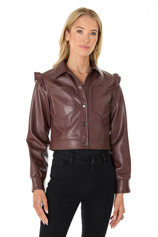 A woman with blonde hair wears the Chantal Ruffle Sleeve Leather Jacket in Espresso with black pants against a white background—a striking fall statement piece.