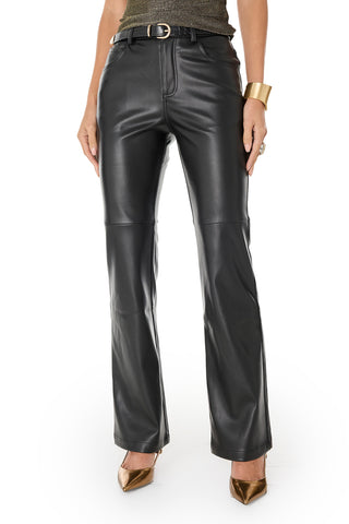 A person wearing the Jackie Leather Pant - Black, a sparkly sleeveless top, a wide gold cuff bracelet, and metallic gold pointed heels stands against a white background.