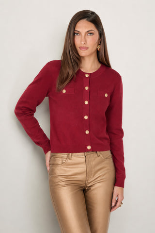 The Loretta Knit Cardigan Top in merlot with padded shoulders, chest pockets, and gold dome buttons