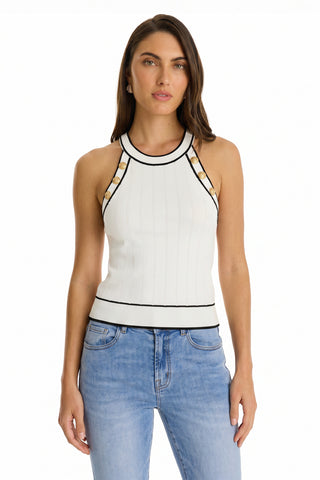 A woman with long brown hair wears the Martha Button Halter Tank in white—a sleeveless, ribbed top with black trim—and light blue jeans as she stands facing forward against a plain white background.