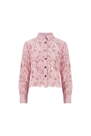 The Mina Lace Blouse - Blush is a semi-sheer, pink floral lace top with long sleeves, a collared button-down front, and solid cuffs and collar for a stylish touch. Delicate patterns complete its elegant look.