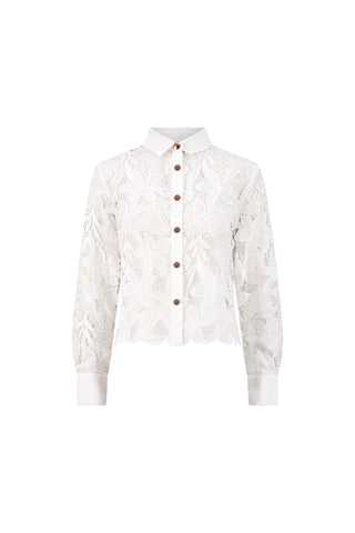 The Mina Lace Blouse - White is a semi-sheer, long-sleeve floral lace blouse with a button-down front, crisp white collar, and white cuffs. It features an elegant floral lace pattern and is shown on a plain white background.
