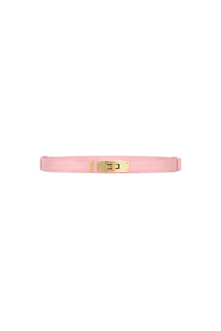 The Nicola Belt - Blush is a slim pink belt with a textured leather strap and a shiny gold rectangular buckle featuring a golden lock closure, shown on a white background.