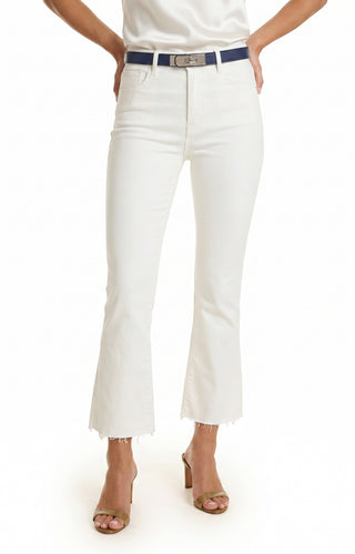 A person wearing Nicolette Cropped Jean - White with frayed hems, a navy belt, and beige heeled sandals stands hands on hips; upper body is partially out of frame.