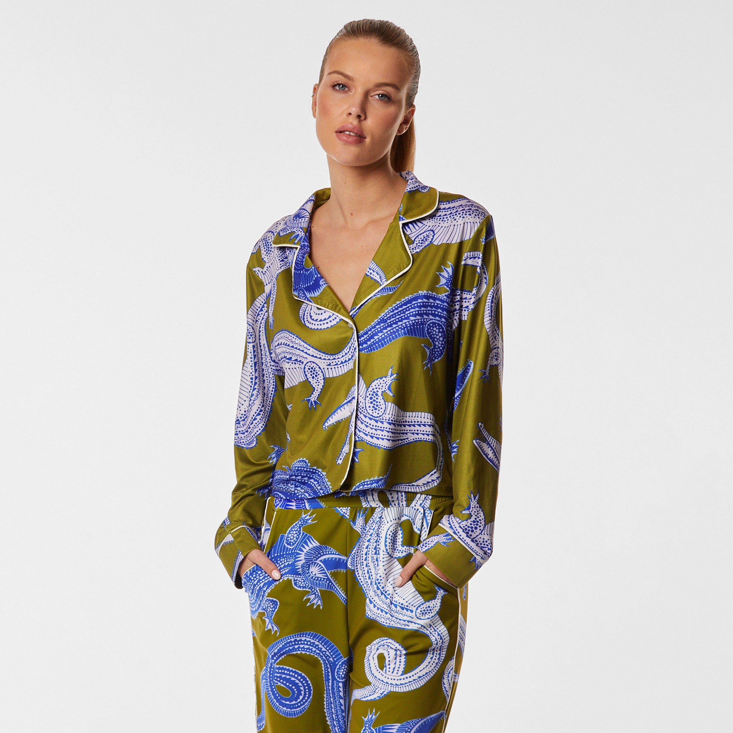 Front view of woman wearing breathable, relaxed and buttery smooth pajama shirt featuring a button front top with notch collar and Nile gator print.