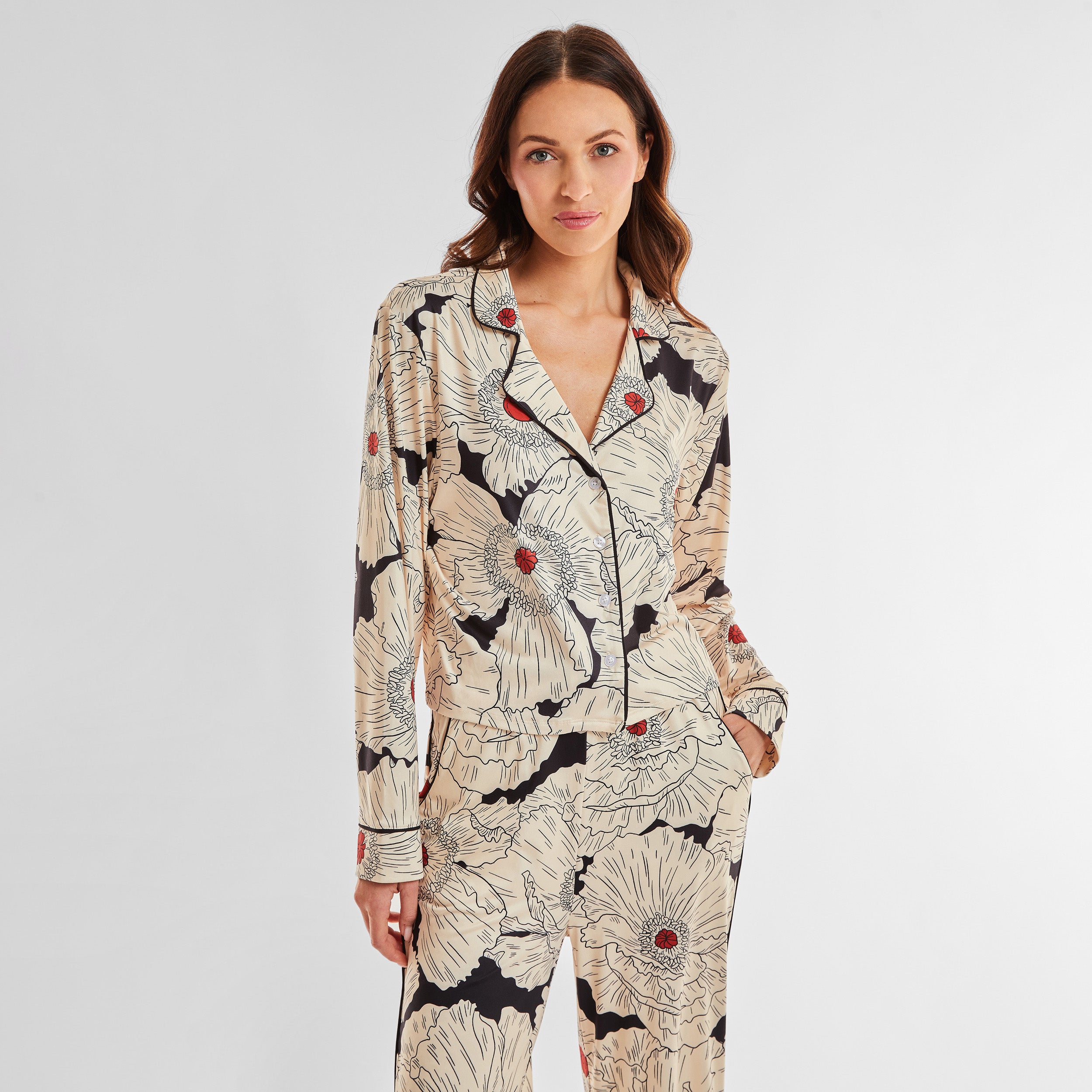 Front view of woman wearing breathable, relaxed and buttery smooth pajama shirt featuring a button front top with notch collar and Poppy Floral print.