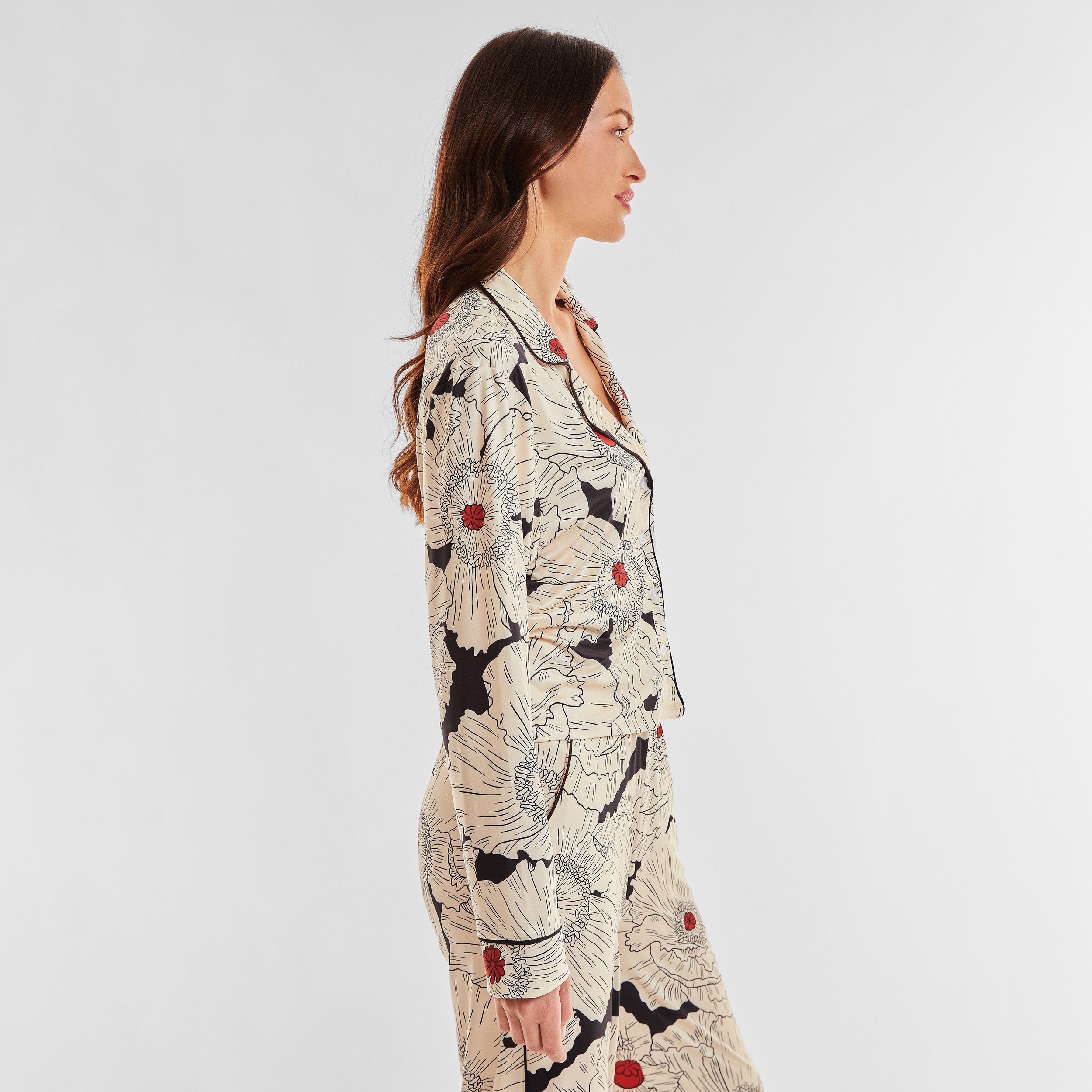 Side view of woman wearing breathable, relaxed and buttery smooth pajama shirt featuring a button front top with notch collar and Poppy Floral print.