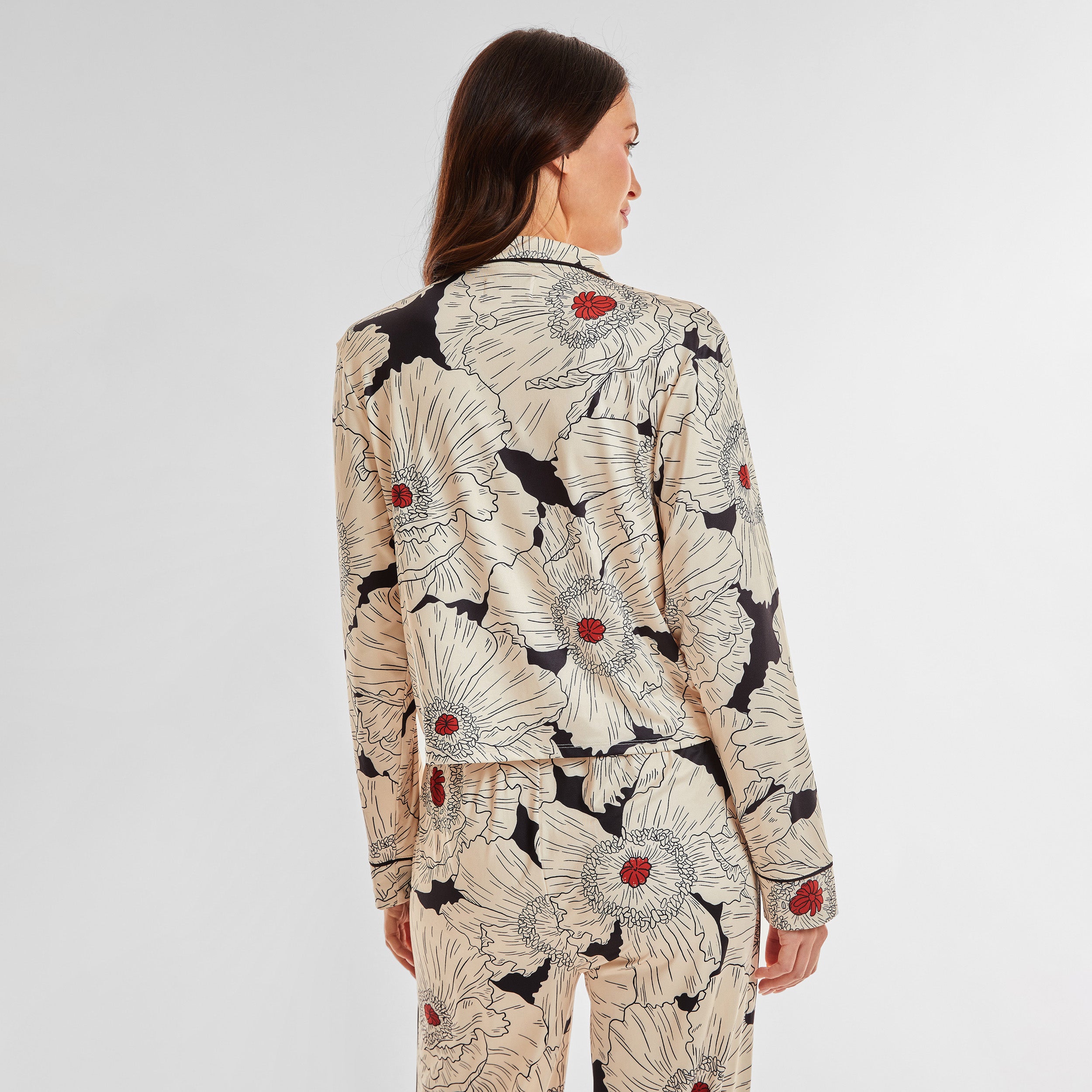 Rear view of woman wearing breathable, relaxed and buttery smooth pajama shirt featuring a button front top with notch collar and Poppy Floral print.