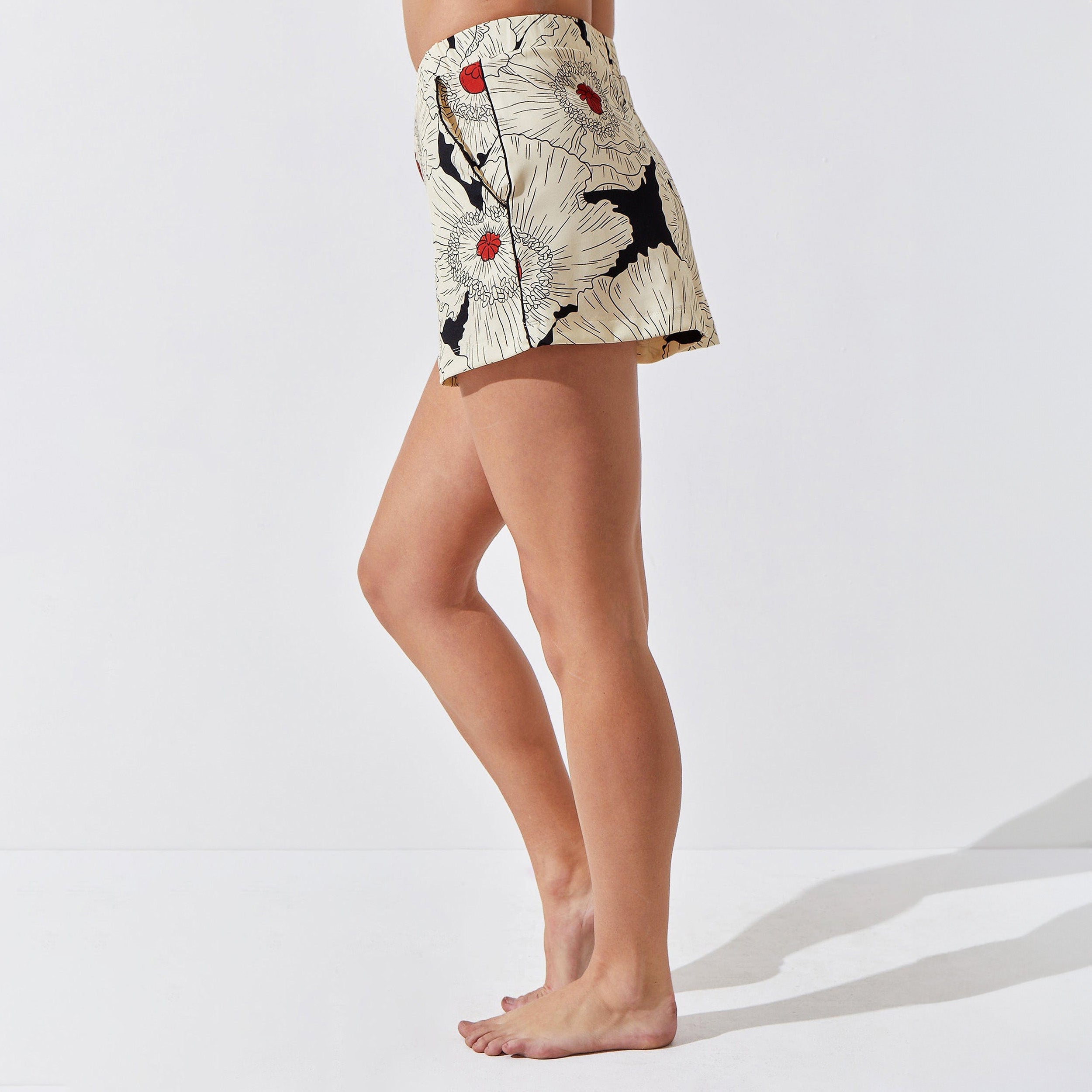 Side view of woman wearing breathable, relaxed and butter smooth pajama short featuring a high-waist cut, side pockets and stunning Poppy floral print