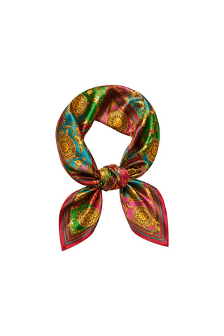 The Printed Satin Scarf - Dolce Sun features a silky baroque print in green, red, and gold with sun medallion-inspired circular motifs, loosely knotted against a white backdrop.