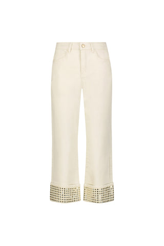 The Ren Cropped Cuff Jean - Gold Mirror is a cream-colored, four-way stretch denim with wide turned-up hems adorned with metallic gold studs, shown against a plain white background.