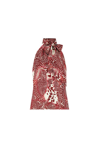 Elegant and chic, the Rina Tie Neck Blouse - Garnet Crush features a sleeveless design, abstract white and burgundy dots, and a bold bow at the neckline—a striking statement piece for any wardrobe.