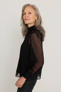 Darcy Chiffon Blouse in Black, side view showing the sheer sleeve, gathered mock neck and relaxed drape, The Noli Shop