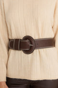 Biarritz Belt in Espresso worn at the waist over the Ingrid Sweater in Latte, close view of the covered round buckle and contrast topstitching