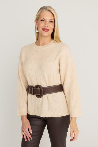 Ingrid Sweater in Latte, a wide-rib crewneck knit, front view belted with the Biarritz Belt in Espresso over the Aria Coated Flare Jean in Espresso