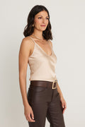 Yara Silk Camisole in Champagne, side view showing the satin sheen and relaxed drape, with espresso coated flare jeans and a gold square buckle belt, The Noli Shop