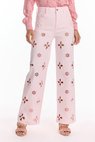Wearing the Kaia Pearl High Rise Jean in Blush with a pink textured blouse and pale pink woven sandals creates a coordinated, stylish look.
