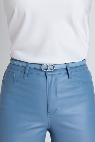 The Mabel Belt in coastal blue worn at the waist, showing the gold braided oval buckle