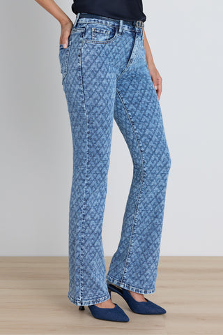 Detail of the Aria Flare Jean in atelier blue showing the woven monogram pattern