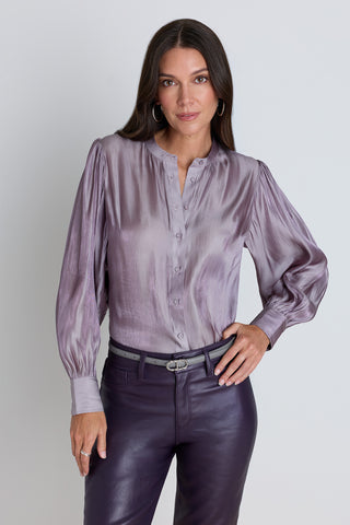 The Colette Blouse in Lavender, a pale lavender satin blouse with statement sleeves and a high collar, styled with the Aria Coated Flare Jean in Midnight Plum