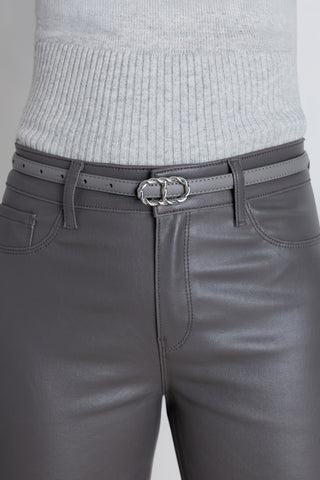 The Mabel Belt in grey chateau worn at the waist, showing the silver braided oval buckle