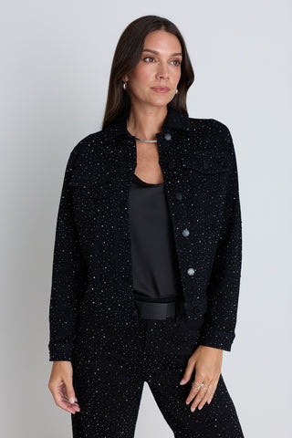 The Sybil Crystal Denim Jacket in Black on model, a slim full-length black denim jacket with crystal embellishment, worn with the matching Hallie Crystal Jean