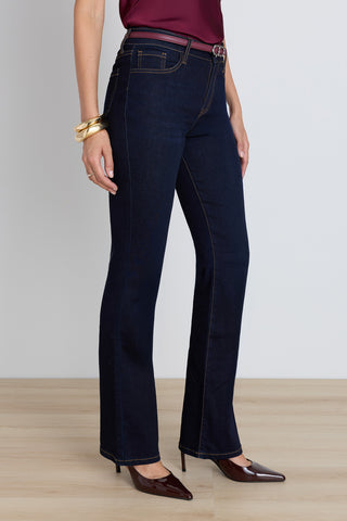 Detail of the Aria Flare Jean in indigo showing the yellow contrast stitching