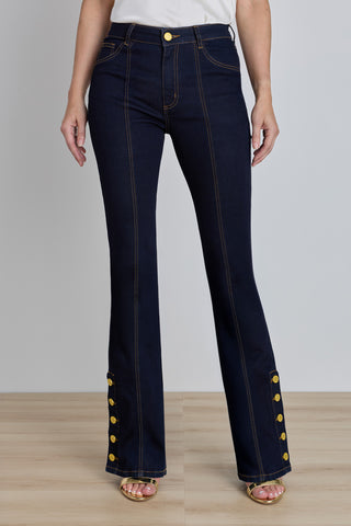 The Veronica Button Jean in indigo, mid-rise flared dark denim with gold buttons at the ankle