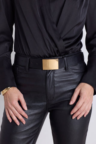 The Bianca Belt in black worn at the waist, showing the gold rectangular buckle
