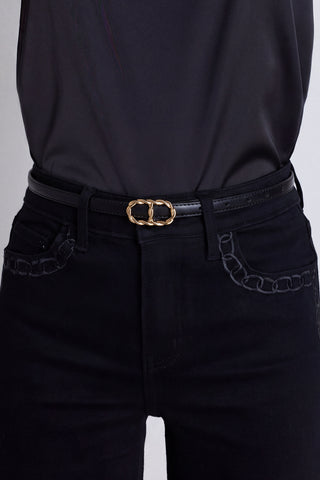 The Mabel Belt in black and gold worn at the waist, showing the twisted gold buckle