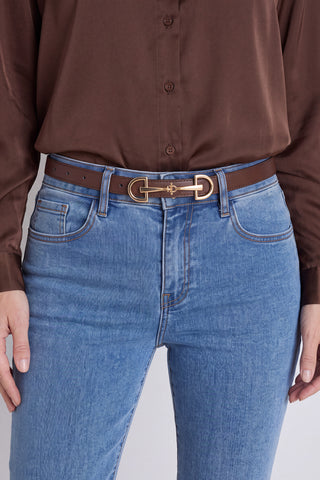 The Heritage Belt in java worn at the waist, showing the brown leather and gold horsebit buckle
