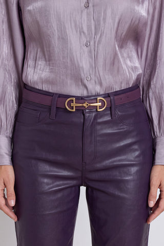 The Heritage Belt in midnight plum worn at the waist, showing the gold horsebit detail