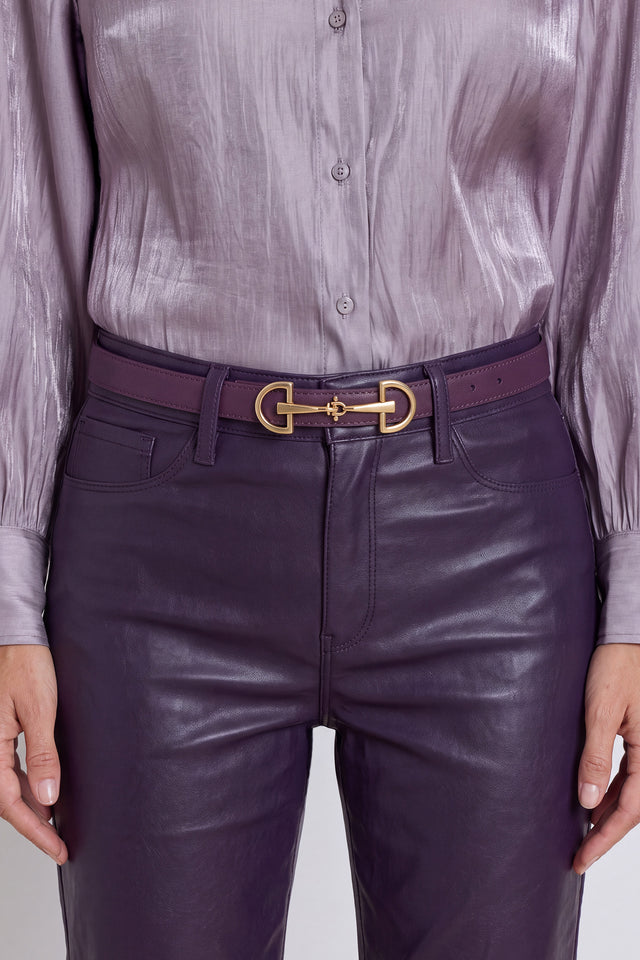 The Heritage Belt in midnight plum worn at the waist, showing the gold horsebit detail