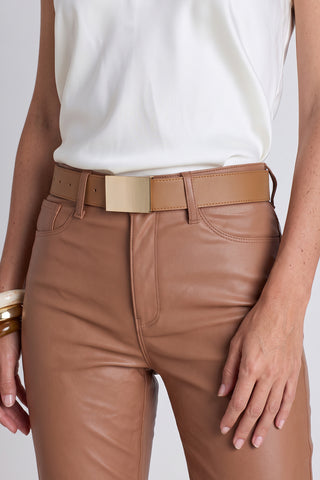 The Bianca Belt in mocha worn at the waist, showing the tan leather and gold buckle