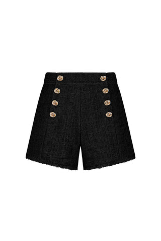The Tamara Tweed Button Short in black features six gold buttons in two vertical rows, a textured tweed finish, and a chic gold side zipper.