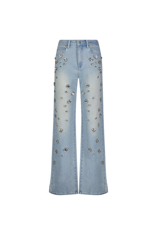 The Tara Crystal Jean - Light Blue is a pair of high-rise stretch denim jeans featuring silver floral embellishments on the front, shown against a white background.