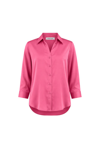 The Sara Silk Blouse in Petal Pink is a lightweight, long-sleeved women’s top with a shiny, smooth silk fabric, relaxed fit, curved hem, and collared button-down design. It’s pattern-free and unembellished for a classic look.