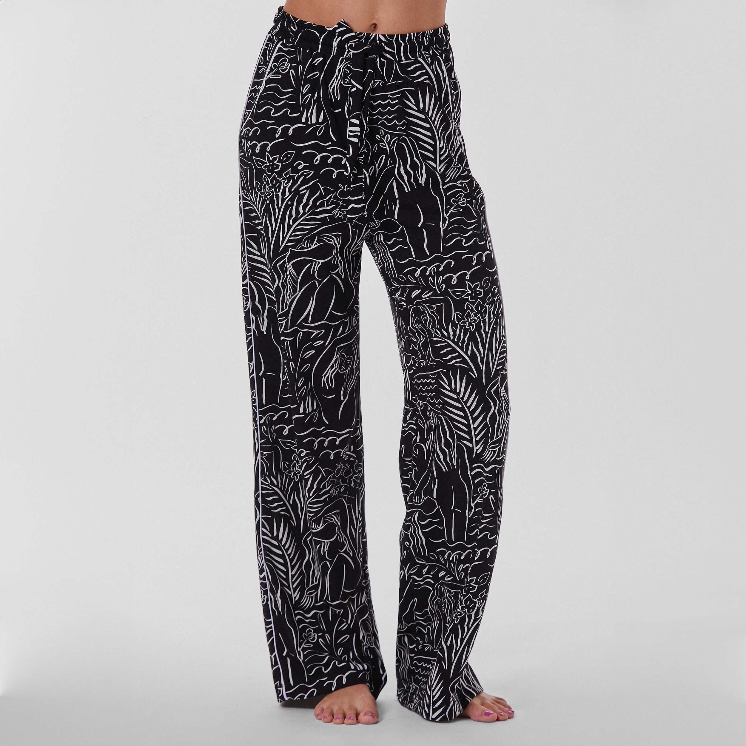 Front view of woman wearing breathable, relaxed and buttery smooth pajama pant featuring high-waist cut, side pockets, front tie and stunning Venus print.