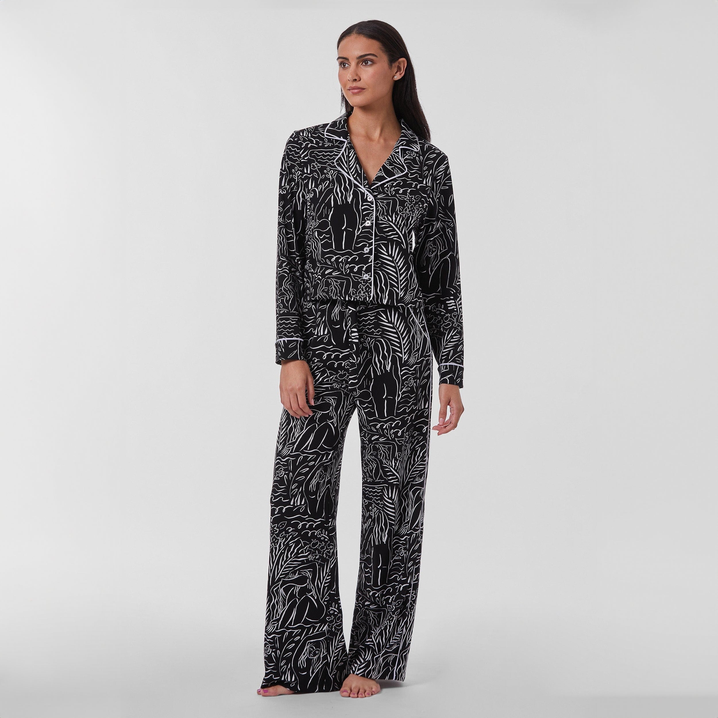 Full view of woman wearing breathable, relaxed and buttery smooth pajama pant featuring high-waist cut, side pockets, front tie and stunning Venus print.