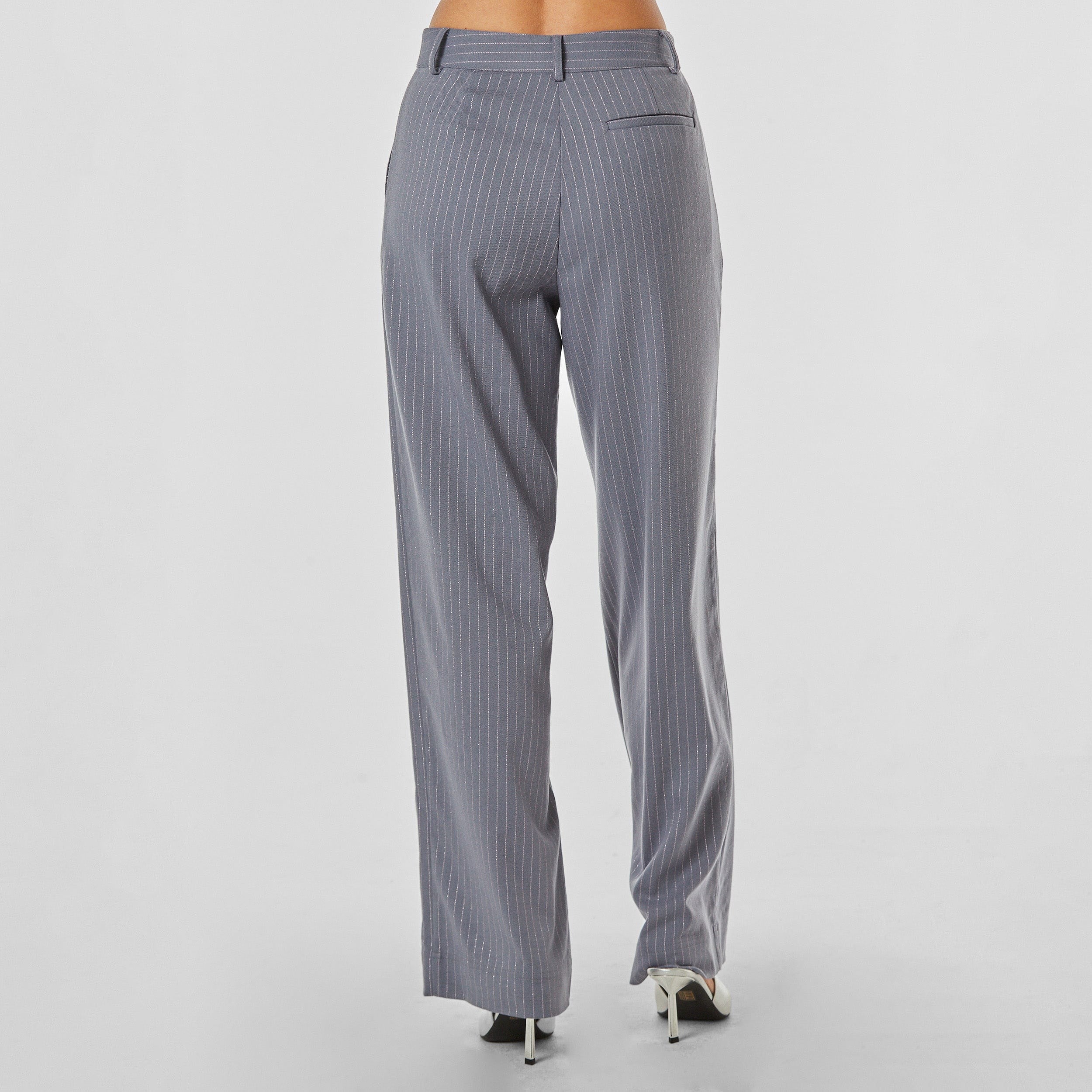 Rear view of woman wearing silver pinstripe on grey trouser with oversized fit